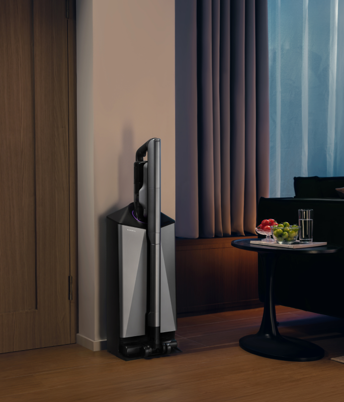 Narwal V50 Cube station in a dim living room beside a sofa