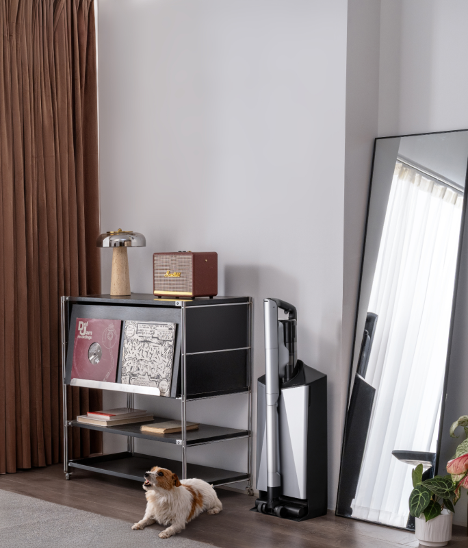 Narwal V50 Cube station beside shelving, a mirror, and a dog