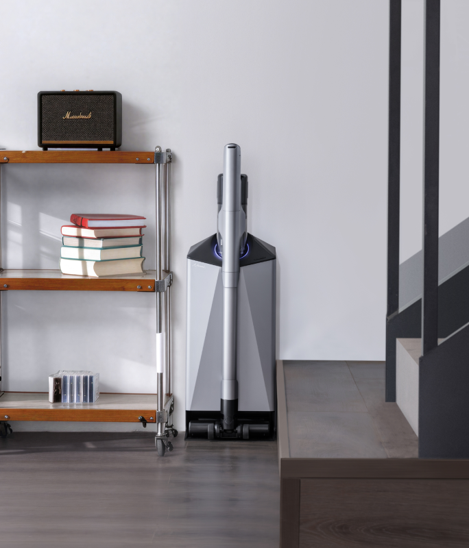 Narwal V50 Cube station beside shelving at the foot of a staircase
