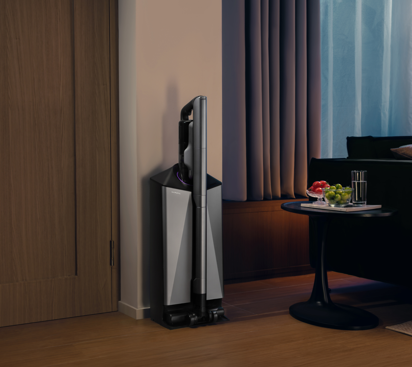 Narwal V50 Cube station in a dim living room beside a sofa