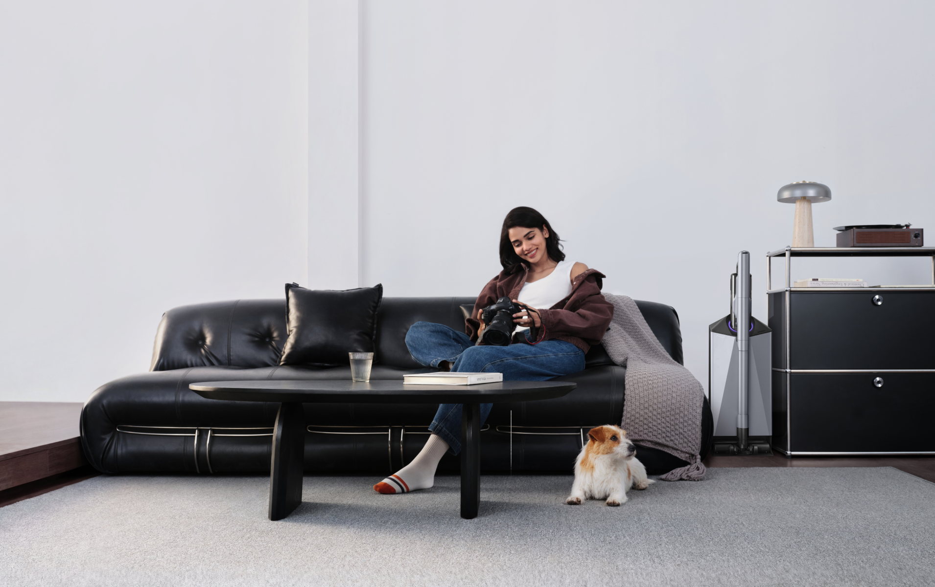 Narwal V50 Cube station beside a sofa with a woman and dog