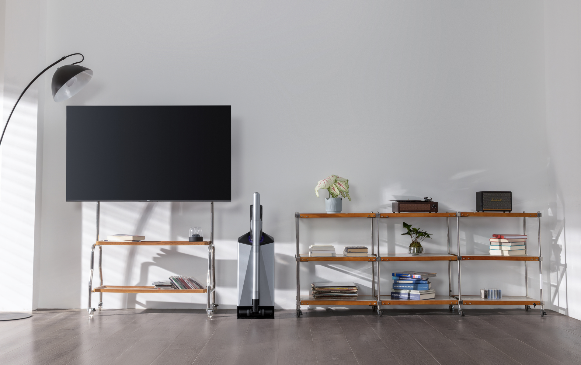 Narwal V50 Cube station between a TV and shelving in a bright living room